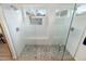 Modern shower features dual shower heads, pebble flooring, and a glass enclosure, creating a spa-like experience at 14241 N 56Th Pl, Scottsdale, AZ 85254