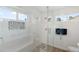 Bright shower features pebble floor, tiled walls, and plenty of natural light, creating a spa-like retreat at 14241 N 56Th Pl, Scottsdale, AZ 85254