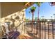 Balcony with outdoor chair overlooking the street and mature palm trees at 14261 N Oakwood Ln, Fountain Hills, AZ 85268