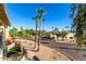 The view from the balcony features lush tropical landscaping, palm trees and other well-maintained buildings at 14261 N Oakwood Ln, Fountain Hills, AZ 85268
