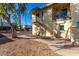 View of condo building featuring wrought iron stairs and walkway through desert landscaping on a bright sunny day at 14261 N Oakwood Ln, Fountain Hills, AZ 85268