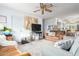 Bright living room with wood floors, neutral paint, ceiling fan, and view of kitchen and dining area at 14261 N Oakwood Ln, Fountain Hills, AZ 85268