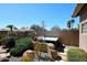 Private backyard featuring a relaxing hot tub surrounded by lush desert landscaping at 15061 W Pinchot Ave, Goodyear, AZ 85395