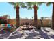 Beautiful backyard featuring a decorative waterfall, a comfortable seating area, and lush landscaping at 15061 W Pinchot Ave, Goodyear, AZ 85395