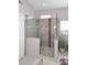 Modern walk-in shower features stylish tiling, a rainfall shower head, and plenty of natural light at 15061 W Pinchot Ave, Goodyear, AZ 85395