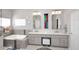 Bright bathroom with a soaking tub, dual sinks, modern fixtures, and ample vanity storage at 15061 W Pinchot Ave, Goodyear, AZ 85395