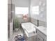 Contemporary bathroom with soaking tub featuring a decorative tile surround, large window, and modern fixtures at 15061 W Pinchot Ave, Goodyear, AZ 85395