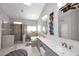 Contemporary bathroom featuring a walk-in shower, soaking tub, double sink vanity, and stylish decor at 15061 W Pinchot Ave, Goodyear, AZ 85395