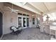 Inviting covered patio with ceiling fans, stylish seating, and an outdoor bar area perfect for entertaining at 15061 W Pinchot Ave, Goodyear, AZ 85395