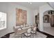 Dining room with large wall art, decorative features, and view of the living area at 15061 W Pinchot Ave, Goodyear, AZ 85395