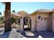 Close up of the front of the home featuring a private gated entrance, and mature landscaping at 15061 W Pinchot Ave, Goodyear, AZ 85395