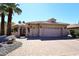 Home featuring a neutral color, brick driveway, and a large three-car garage at 15061 W Pinchot Ave, Goodyear, AZ 85395