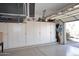Spacious garage with wall-to-wall storage cabinets and epoxy floors for easy organization and maintenance at 15061 W Pinchot Ave, Goodyear, AZ 85395