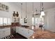 The kitchen showcases stainless appliances, marble countertops, gas cooktop, and natural light at 15061 W Pinchot Ave, Goodyear, AZ 85395