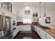 Modern kitchen featuring stainless appliances, marble countertops, and wood floors at 15061 W Pinchot Ave, Goodyear, AZ 85395