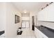 Functional laundry room with white cabinets, a utility sink, and modern appliances for convenience at 15061 W Pinchot Ave, Goodyear, AZ 85395