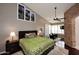 Comfortable bedroom featuring a decorative stone archway, vaulted ceilings, and private seating area with patio access at 15061 W Pinchot Ave, Goodyear, AZ 85395
