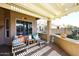 Cozy covered patio featuring comfortable seating, a serving bar, and views of the neighborhood at 15061 W Pinchot Ave, Goodyear, AZ 85395