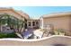 Private courtyard with stone fountain, lounge chairs, brick patio, and mature landscaping at 15061 W Pinchot Ave, Goodyear, AZ 85395