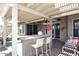 Charming outdoor patio with a built-in bar, stylish seating, and a shaded pergola at 15061 W Pinchot Ave, Goodyear, AZ 85395