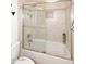 Shower with neutral toned tiling and glass sliding doors at 15061 W Pinchot Ave, Goodyear, AZ 85395