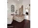 Entertainers wet bar features stone accents, wine storage and access to the kitchen and living areas at 15061 W Pinchot Ave, Goodyear, AZ 85395