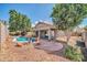 Desert landscaped backyard featuring a covered patio and refreshing pool at 15856 W Calavar Rd, Surprise, AZ 85379