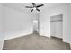 A spacious bedroom featuring a ceiling fan, closet, and neutral paint at 15856 W Calavar Rd, Surprise, AZ 85379