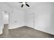 A large bedroom with a ceiling fan, closet, and neutral paint at 15856 W Calavar Rd, Surprise, AZ 85379