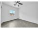A bright bedroom featuring a ceiling fan, natural light, and neutral paint at 15856 W Calavar Rd, Surprise, AZ 85379