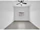 A clean and airy bedroom features a tiled floor and a ceiling fan at 15856 W Calavar Rd, Surprise, AZ 85379