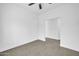 A spacious and bright bedroom with neutral walls and tiled flooring at 15856 W Calavar Rd, Surprise, AZ 85379