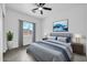 A stylish bedroom featuring a ceiling fan, natural light, decor, and neutral paint at 15856 W Calavar Rd, Surprise, AZ 85379