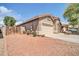 Charming single-story home with a well-manicured front yard and two-car garage at 15856 W Calavar Rd, Surprise, AZ 85379