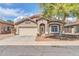 Charming single-story home featuring a low maintenance desert landscape, two car garage, and cozy covered porch at 15856 W Calavar Rd, Surprise, AZ 85379