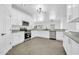 Modern kitchen with sleek stainless steel appliances, granite countertops, and plenty of white cabinets at 15856 W Calavar Rd, Surprise, AZ 85379