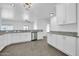 Spacious kitchen featuring sleek countertops, modern appliances, white cabinetry, and an open layout at 15856 W Calavar Rd, Surprise, AZ 85379