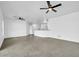 Spacious room featuring tile flooring, ceiling fan, and neutral colors leading to the kitchen at 15856 W Calavar Rd, Surprise, AZ 85379