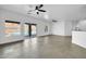 Bright living space with tiled floors, ceiling fan, and sliding glass doors to the backyard pool at 15856 W Calavar Rd, Surprise, AZ 85379
