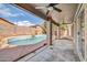 Covered patio offers shade and views of the lovely pool and backyard at 15856 W Calavar Rd, Surprise, AZ 85379
