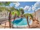 A tranquil pool with palm trees creates a relaxing backyard oasis at 15856 W Calavar Rd, Surprise, AZ 85379