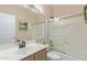 Cozy bathroom featuring a shower and tub combination with glass doors, plus a white sink and wood vanity at 17128 E Kensington Pl, Fountain Hills, AZ 85268