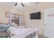 Cozy bedroom featuring a TV, plush carpet, and a view to the outdoor landscaping at 17128 E Kensington Pl, Fountain Hills, AZ 85268
