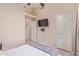 Cozy bedroom featuring hardwood floors, TV, and a closet space at 17128 E Kensington Pl, Fountain Hills, AZ 85268
