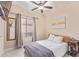 Bedroom featuring hardwood floors, ceiling fan, and a large window for natural light at 17128 E Kensington Pl, Fountain Hills, AZ 85268