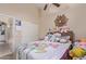 Bright bedroom featuring a ceiling fan, queen bed with a colorful blanket, plus neutral wall color at 17128 E Kensington Pl, Fountain Hills, AZ 85268