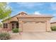 Charming single-story home featuring a two-car garage and desert landscaping with a tiled roof at 17128 E Kensington Pl, Fountain Hills, AZ 85268