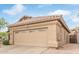 Close-up of a single-story home with a two-car garage and neutral exterior paint at 17128 E Kensington Pl, Fountain Hills, AZ 85268