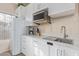 Well-lit kitchen featuring white cabinets, modern appliances, and lots of natural light at 17128 E Kensington Pl, Fountain Hills, AZ 85268