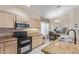 Charming kitchen with stainless steel microwave and double oven, granite countertops, and eat-in dining area at 17128 E Kensington Pl, Fountain Hills, AZ 85268